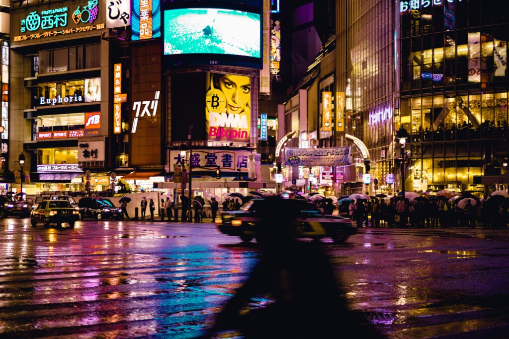 Experience the vibrant nightlife at Shibuya Crossing, Tokyo with neon lights and bustling crowd.