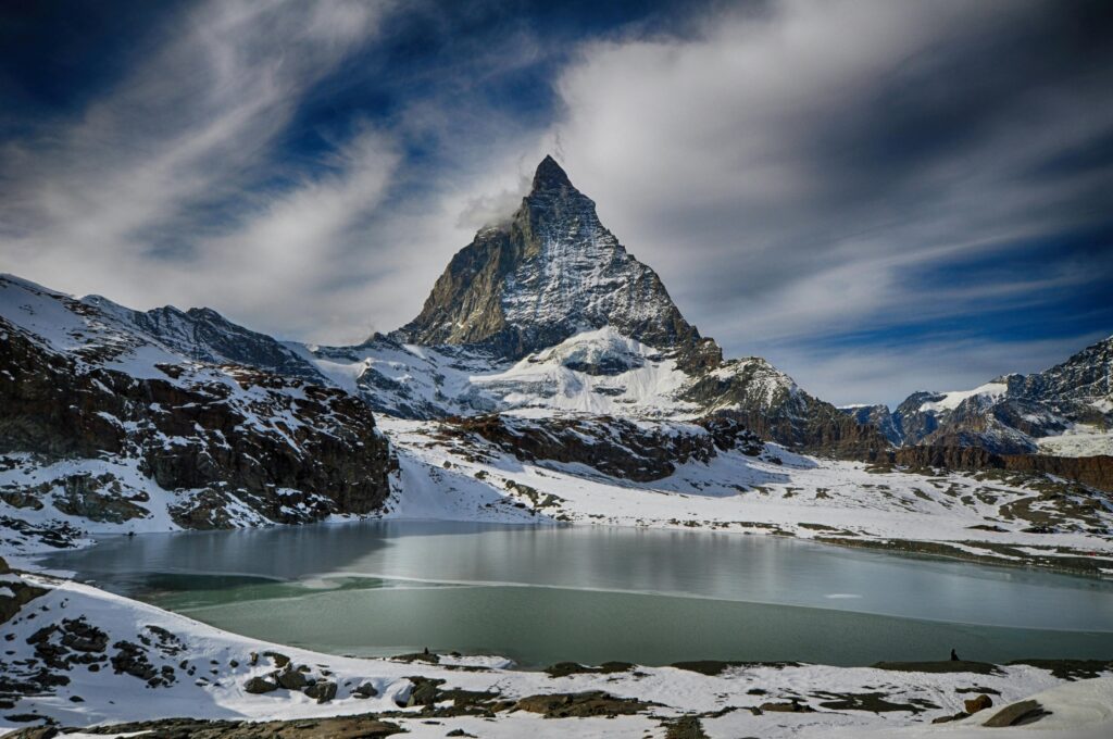 Scenic winter view of the Matterhorn mountain with a lake, perfect for adventure and travel imagery.