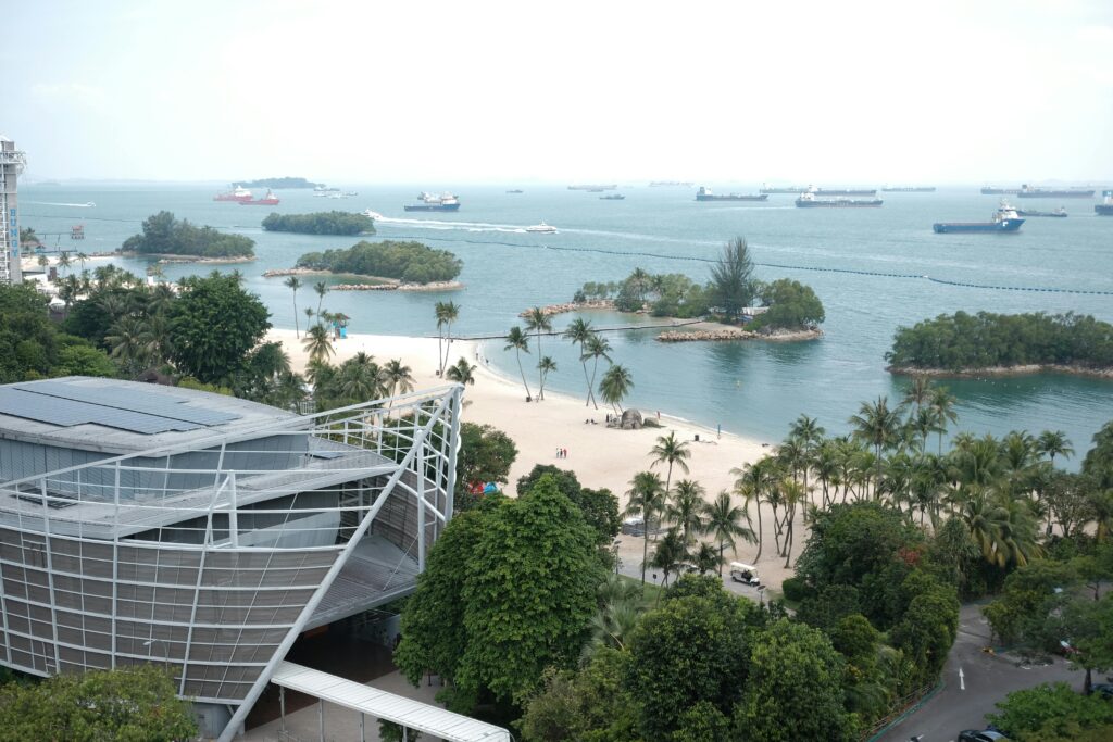 Captivating aerial shot of Singapore's beach with modern buildings and lush greenery.
