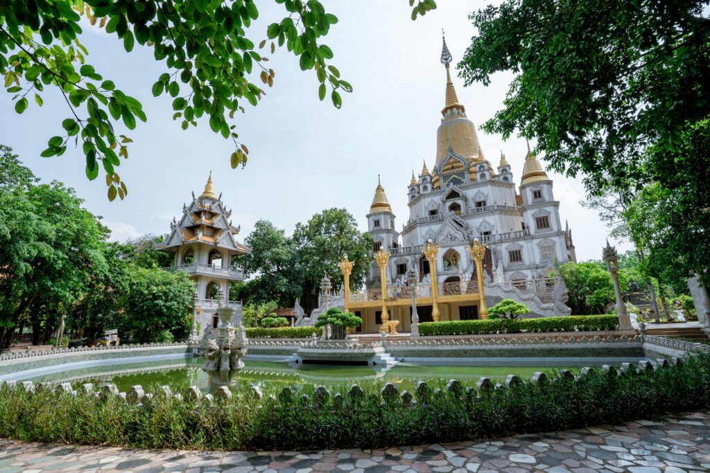 Explore the exquisite Buu Long Pagoda with its intricate architecture surrounded by vibrant gardens in Vietnam.